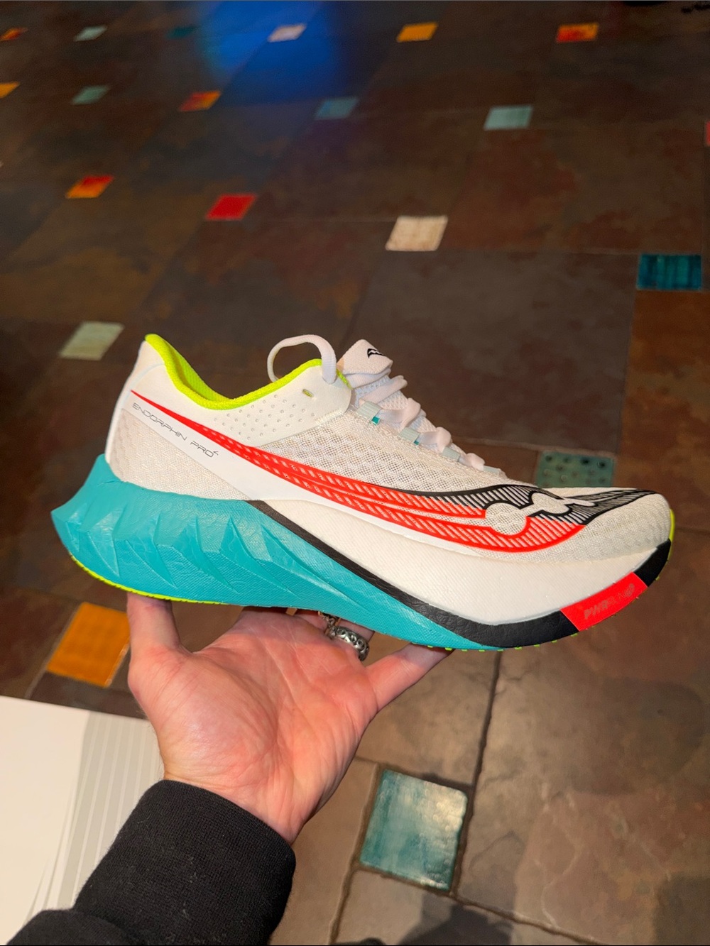 Saucony White Running Shoe with Teal Midsole and Neon Yellow Lining